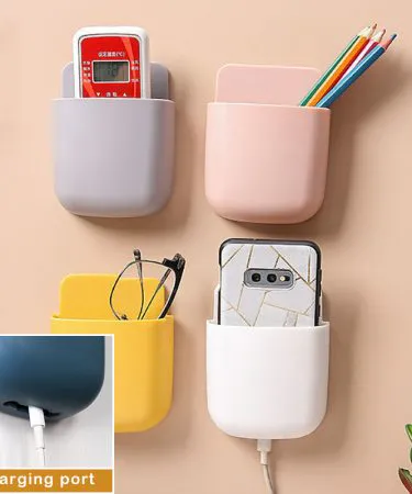 U Shape Wall Mounted Mobile Holder installed on a kitchen wall holding a smartphone and remote, imagecaption=Stylish U‑shape wall‑mounted mobile holder by Khareedo – perfect for phones, remotes, keys and pens,