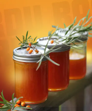 Organic Seabuckthorn Jam jar with fresh berries and mountain backdrop, showcasing 100% chemical‑free, hand‑picked product from Northern Pakistan.