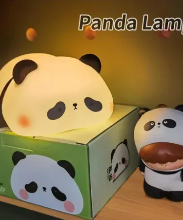 Silicone Panda Night Lamp emitting a soft warm glow on a bedside table, perfect for kids' rooms and nurseries, imagecaption=Adorable silicone panda night lamp adding cozy ambience to any bedroom.