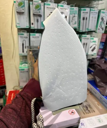 Teflon non‑stick iron cover protecting an iron and fabric, showing easy slide‑on design