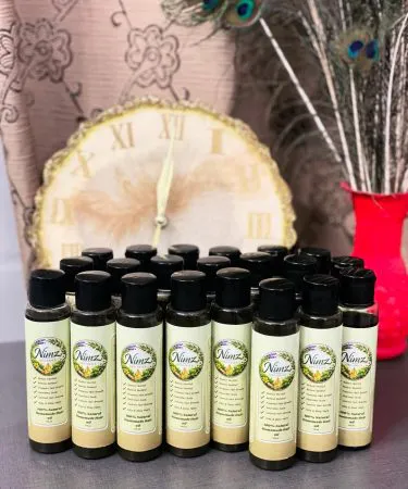 Nimz Herbal Hair Oil bottle with natural herbs and green label, imagecaption=Nimz Herbal Hair Oil – 100% Natural Herbal Formula for Stronger, Shinier Hair,