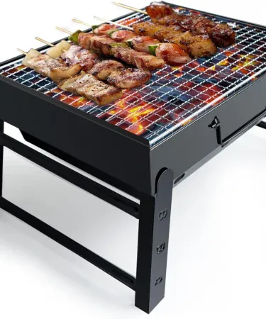Abu Turab (أبو تراب) portable charcoal BBQ grill folded and ready for travel, showing compact design and carry straps