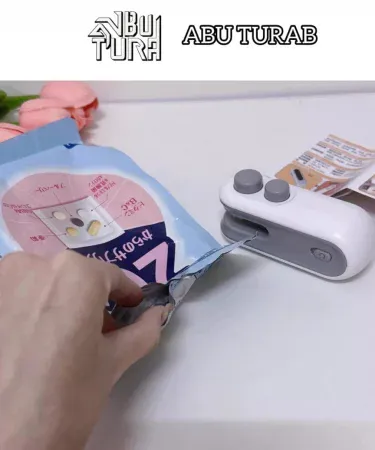 USB rechargeable mini heat sealing machine handheld bag sealer with cutting function, imagecaption=Portable 2‑in‑1 USB rechargeable heat sealing machine for kitchen and travel – available at Khareedo & Kharedo.
