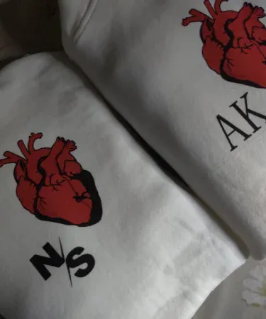 customised human heart printed unisex hoodie in black and white with red heart graphic, imagecaption=Stylish custom heart printed hoodie for men and women – available in black and white on Khareedo|Kharedo.