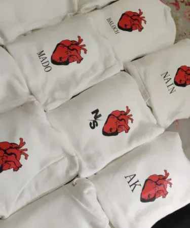 customised human heart printed unisex hoodie in black and white with red heart graphic, imagecaption=Stylish custom heart printed hoodie for men and women – available in black and white on Khareedo|Kharedo.