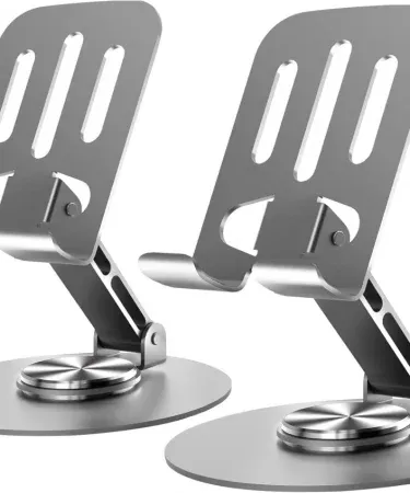 Abū Turāb all‑metal aluminum 360° rotating mobile phone holder with double‑shaft design on a desk, showing its foldable base and silicone anti‑slip pad, imagecaption=Abū Turāb (أبو تراب) universal metal phone stand – portable, stable, and 360° rotatable – available on Khareedo & Kharedo across Pakistan,