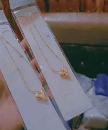 Premium stainless steel kitchenware set with pots, pans, and cutlery displayed on a modern kitchen countertop