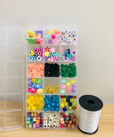 Beads Box for Making Jewelry with Elastic Thread Roll – assorted 18 bead designs in a hard‑plastic compartment with elastic thread roll, imagecaption=Complete DIY jewelry kit with 18 colorful bead designs and elastic thread roll – perfect for creating bracelets, necklaces, and earrings.