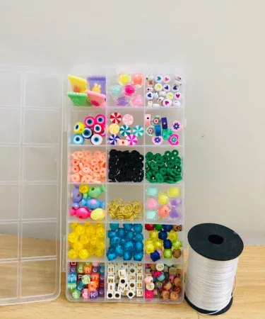 Beads Box for Making Jewelry with Elastic Thread Roll – assorted 18 bead designs in a hard‑plastic compartment with elastic thread roll, imagecaption=Complete DIY jewelry kit with 18 colorful bead designs and elastic thread roll – perfect for creating bracelets, necklaces, and earrings.