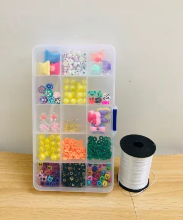 Beads box with elastic thread roll – colorful plastic beads for jewelry making, imagecaption=Colorful bead craft kit with elastic thread roll – perfect for kids and DIY jewelry,