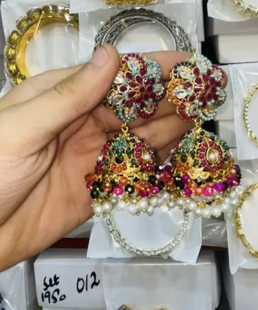 ZARCON+NAURATAN multi earrings displayed on a velvet stand, showcasing layered design , imagecaption= ZARCON+NAURATAN Multi Earrings – perfect for weddings and festive events ,