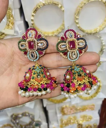 ZARCON+NAURATAN multi earrings displayed on a velvet stand, showcasing layered design , imagecaption= ZARCON+NAURATAN Multi Earrings – perfect for weddings and festive events ,