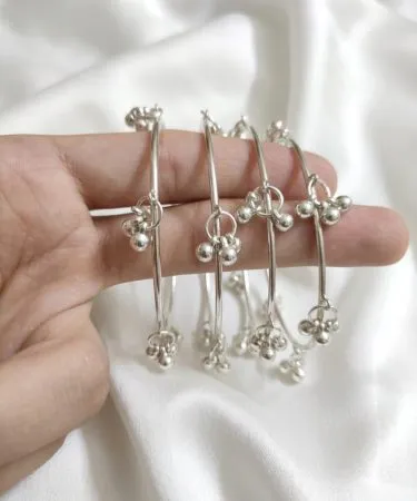 handcrafted silver Kashmiri bangles with intricate embroidery on a velvet background, imagecaption=Elegant handcrafted Kashmiri bangles available on Khareedo|Kharedo – shop now with COD.