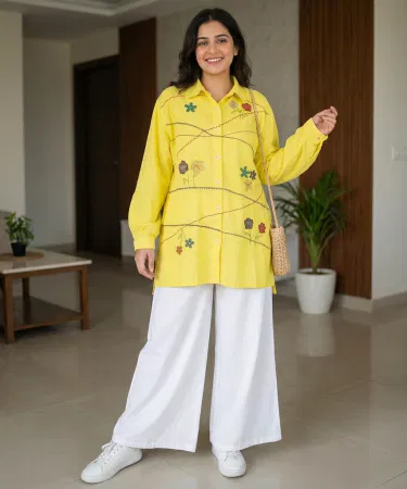 Yellow summer cotton shirt displayed on a mannequin against a bright sunny backdrop , imagecaption=Bright yellow summer cotton shirt – perfect for staying cool and stylish during the Pakistani summer ,