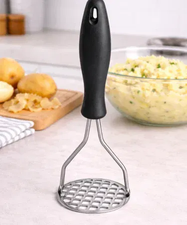 Heavy duty stainless steel potato masher with ergonomic non‑slip handle on kitchen counter, imagecaption=Stainless steel potato masher – perfect for smooth mashing of potatoes, vegetables, and fruits,