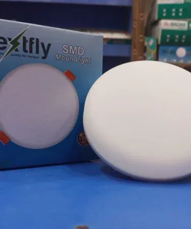 Nextfly 12W SMD Moon Light LED lamp glowing softly in a dark room, imagecaption=Nextfly 12W SMD Moon Light – perfect ambient lighting for any space.