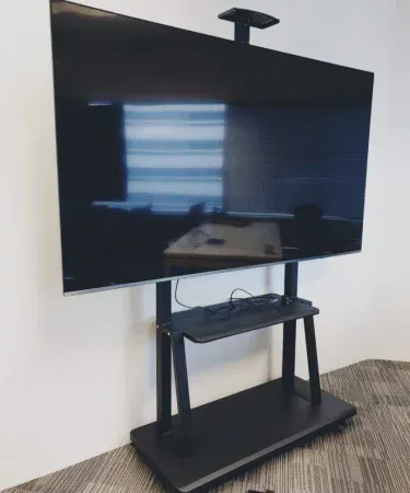 Portable TV Stand Bracket TL1800 – mobile TV stand with roller and player shelf, black cold‑steel design, supporting 40‑100 inch screens