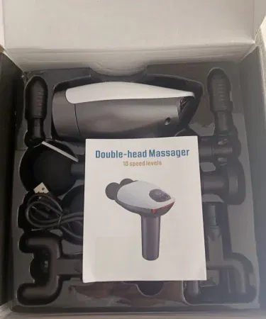 Dual Head Gun Massager with 8 interchangeable heads on white background, imagecaption=ARG Dual Head Gun Massager – 10 speed levels, USB rechargeable, noiseless operation,