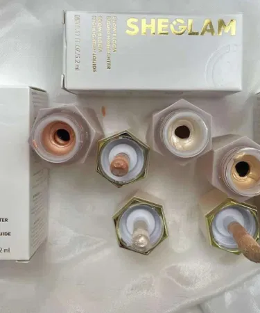 SheGlam Glow Liquid Highlighter in elegant bottle with shimmering light reflection, showcasing Pearl Glow, Rose Gold, and Bronze Gleam shades.
