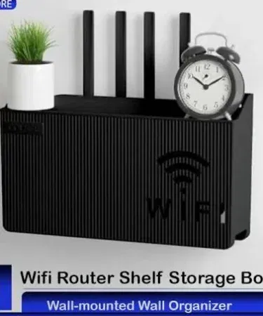 Wall mounted wireless WiFi router shelf made of ABS plastic in random color, mounted on a modern home wall showing ventilation slots and clean cable management, imagecaption=Stylish wall‑mounted router shelf keeping your WiFi device organized and cool.