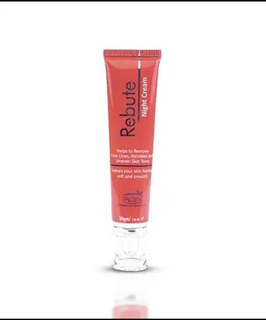 Rebute Advanced Night Repair Cream in a sleek white jar with a soft purple lid, placed on a marble vanity with a night lamp in the background