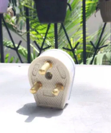 Universal brass three pin to two pin power plug adapter for travel in Pakistan