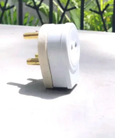 Universal brass three pin to two pin power plug adapter for travel in Pakistan