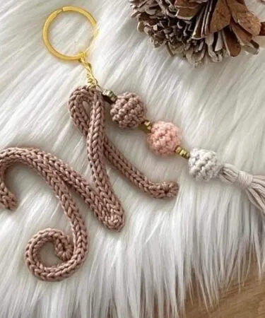 Handmade personalized crochet name shape keychain with custom letter charm, perfect for gifts.