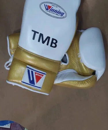 Winning 16oz cowhide leather boxing gloves in gold and white, unisex, sold on Khareedo Pakistan.