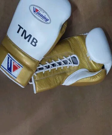 Winning 16oz cowhide leather boxing gloves in gold and white, unisex, sold on Khareedo Pakistan.