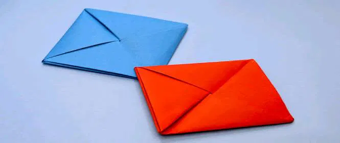 Blue and red Ddakji paper flip toy game, hand-folded origami craft for kids.