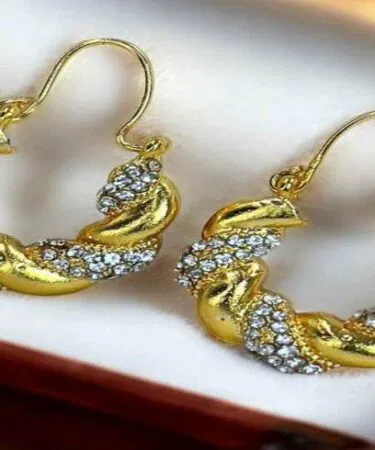Women's golden twist hoop earrings with crystal embellishments, synthetic imitation copper alloy, party wear, sold in Pakistan