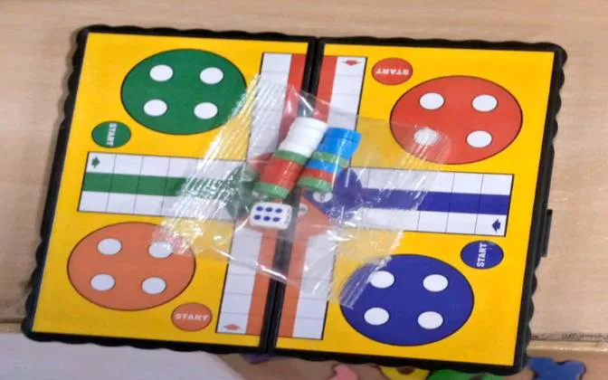 Mini portable Ludo board game set for 2-4 players, durable plastic and cardboard, suitable for kids and adults in Pakistan.