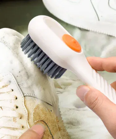 Automatic liquid soap dispensing brush for shoes and clothes with soft bristles, easy grip, durable, sold in Pakistan