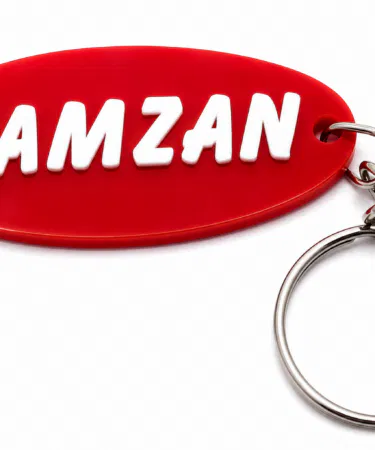 Customized acrylic brand name keychain with metal ring, ideal for car, bike, and home keys.