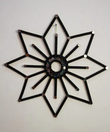 Zaariyan handmade geometric flower wall hanging with mirror accents, black finish, eco-friendly decor