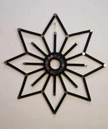 Zaariyan handmade geometric flower wall hanging with mirror accents, black finish, eco-friendly decor