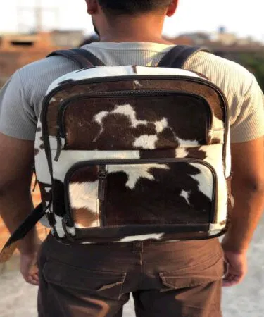 Genuine hair-on cowhide leather handmade rucksack, Western Boho style, unisex, zip closure, white/brown, sold in Pakistan