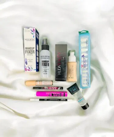 8 in 1 makeup set for women in Pakistan including fixer, foundation, primer, lip pencil, eyeliner, concealer, mascara, and nail polish.