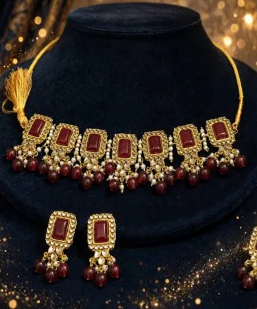 Handmade Kundan jewellery set with red stones and pearls, antique gold finish, for women in Pakistan