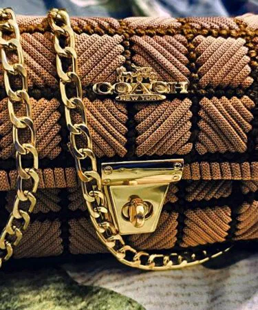 Light pinkish brown handmade woven macrom canvas clutch bag with gold chain for women sold in Pakistan