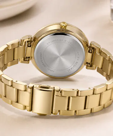 Elegant gold women's watch with green dial, crystal bezel, and date display, sold in Pakistan.