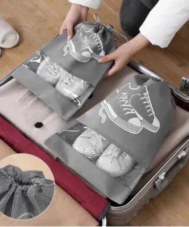 Non-woven fabric travel shoe pouch with visual window and drawstring closure, dustproof and breathable storage bag.